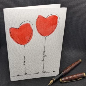 Carte de voeux, avec deux coeurs à l'aquarelle et un texte Amour Toujours