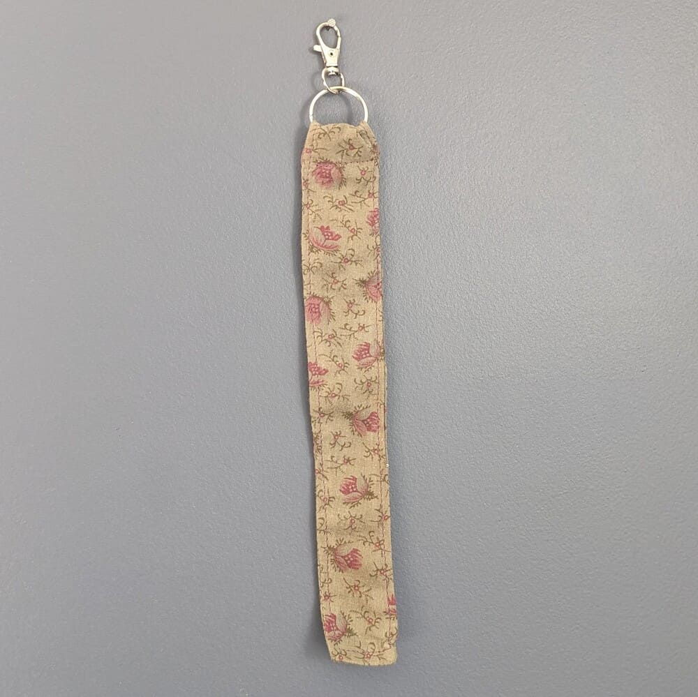 Porte clé fleurs sur fond kaki